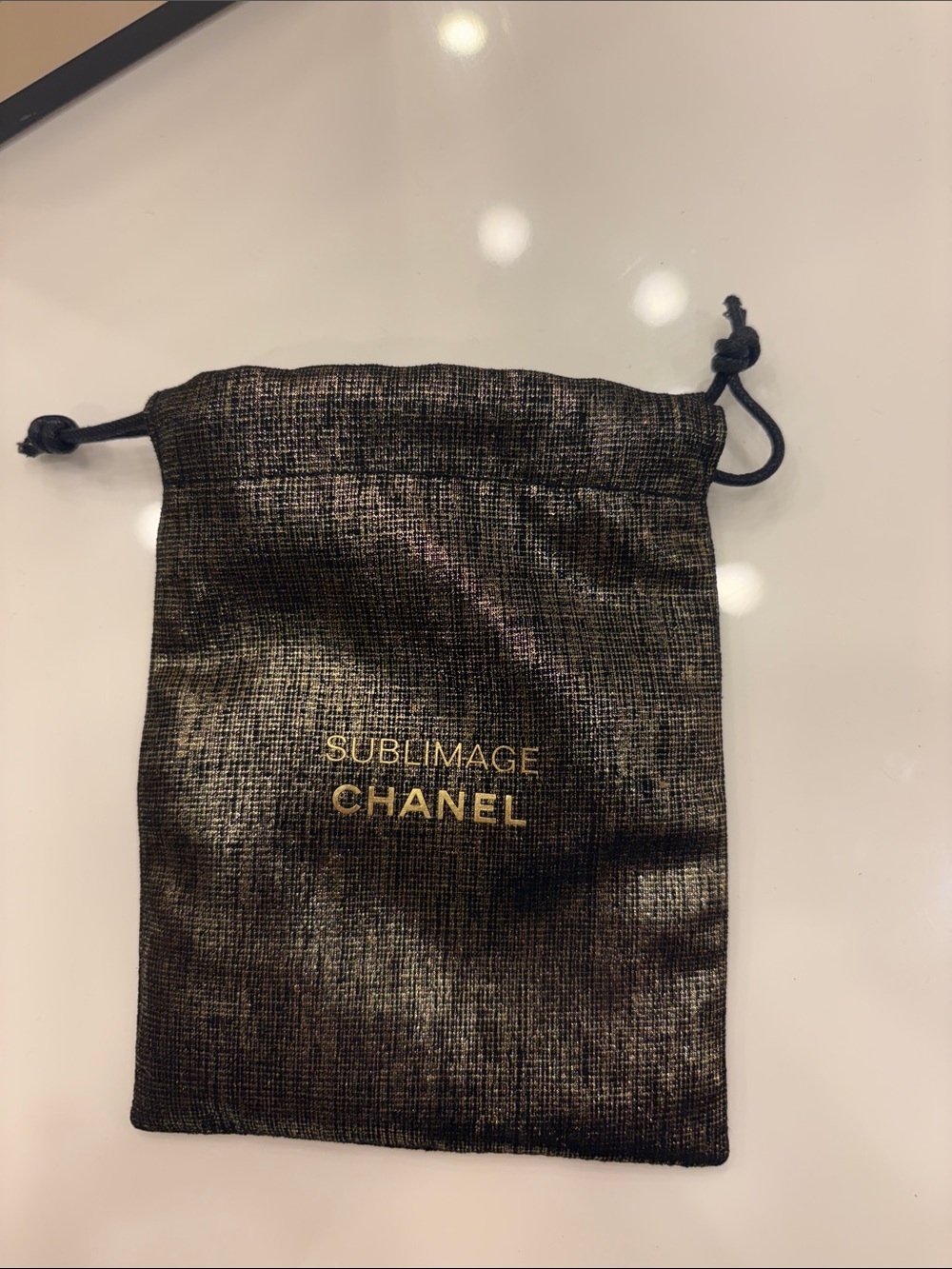 CHANEL Sublimage Metallic Drawstring Pouch in Black with Gold Logo